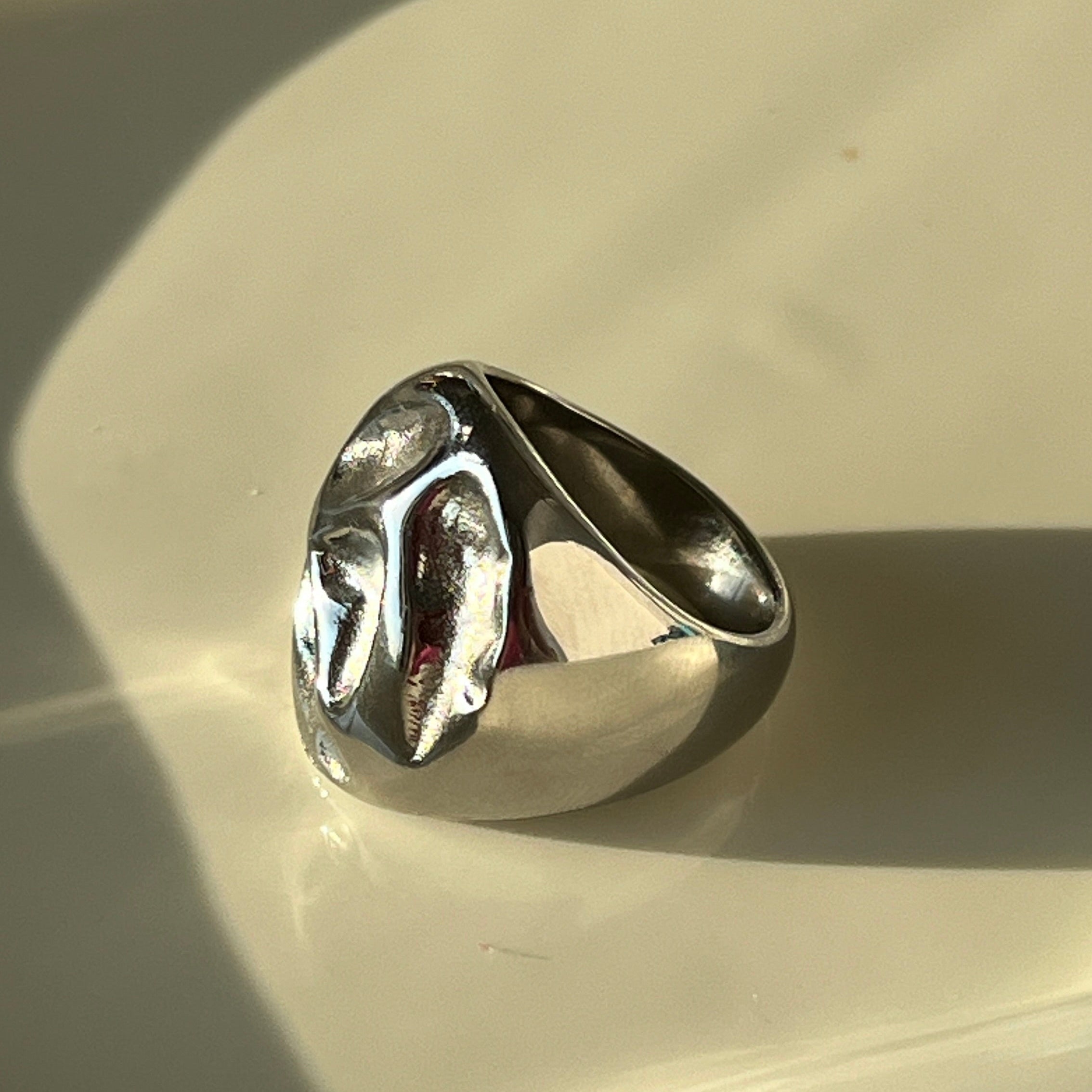 Irregular bold chunky ring in PVD-coated 925 silver-plated stainless steel product shot on a soft white background